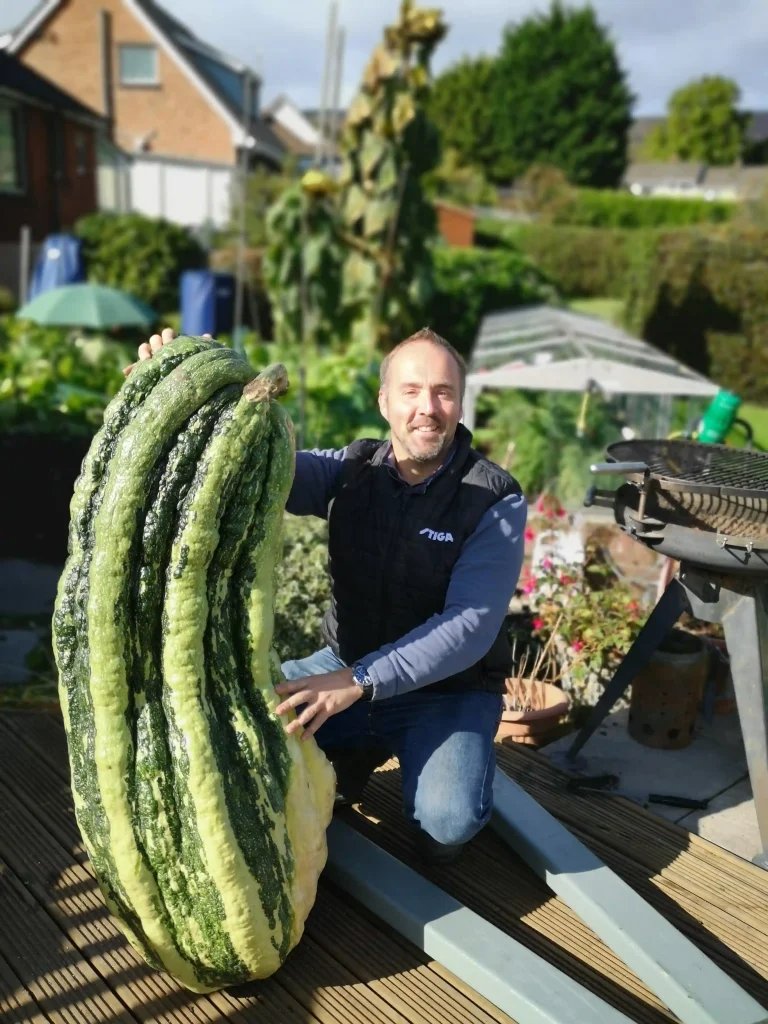 Kevin Fortey, Britain's giant veg king, breaks new records with a 21ft cucumber and 16-inch aubergine, adding to his impressive 11 world records in colossal fruit and veg growing.