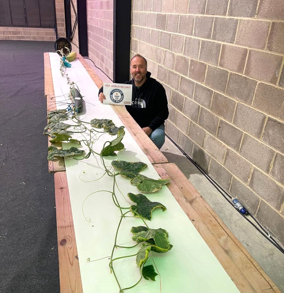 Kevin Fortey, Britain's giant veg king, breaks new records with a 21ft cucumber and 16-inch aubergine, adding to his impressive 11 world records in colossal fruit and veg growing.