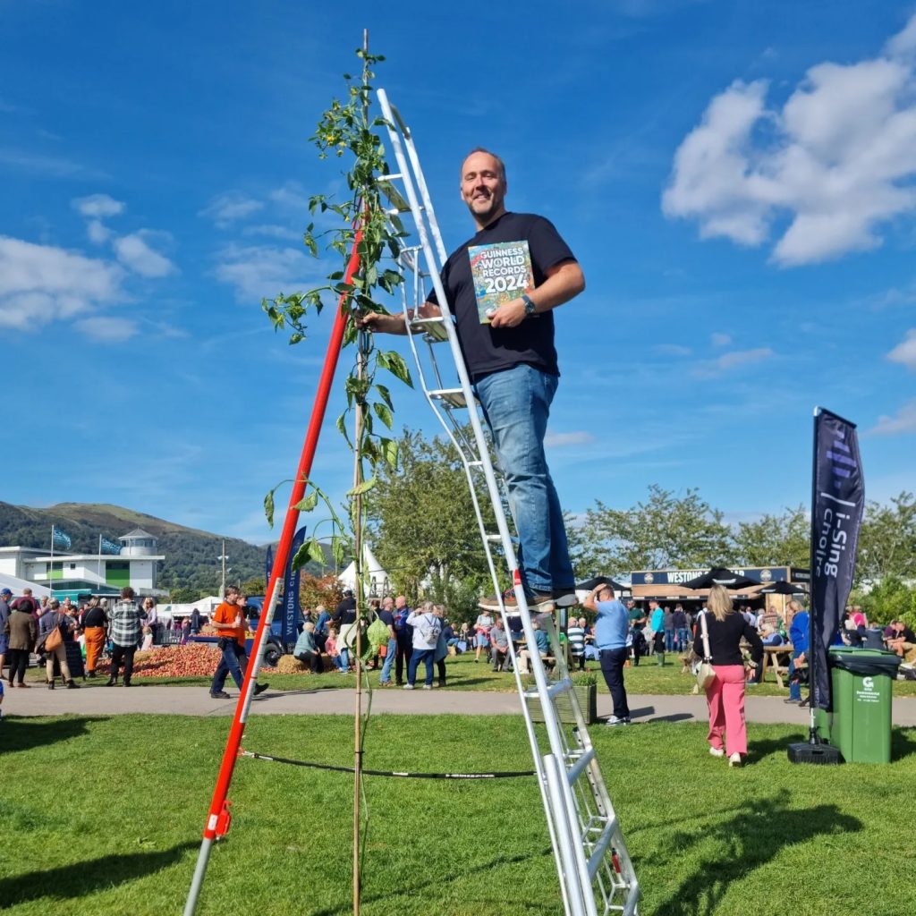 Kevin Fortey, Britain's giant veg king, breaks new records with a 21ft cucumber and 16-inch aubergine, adding to his impressive 11 world records in colossal fruit and veg growing.