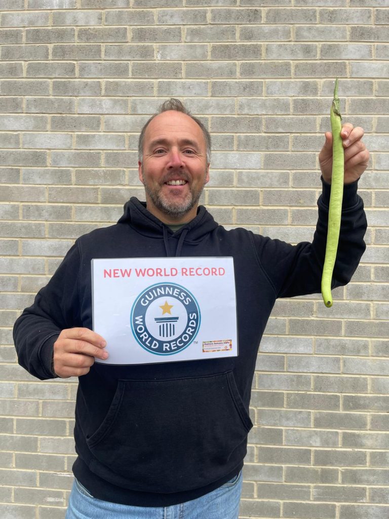 Kevin Fortey, Britain's giant veg king, breaks new records with a 21ft cucumber and 16-inch aubergine, adding to his impressive 11 world records in colossal fruit and veg growing.