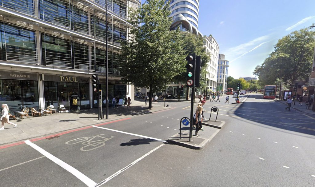 A motorist in London attempted to drive off after crashing his car into a traffic light, leaving two wheels in the air, sparking onlookers' jokes and a police investigation.