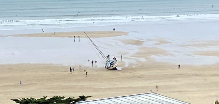 A yacht ran aground on Cornwall's Polzeath beach after the skipper reportedly took a “wrong turn,” sparking a coastguard rescue and drawing curious onlookers to the scene.