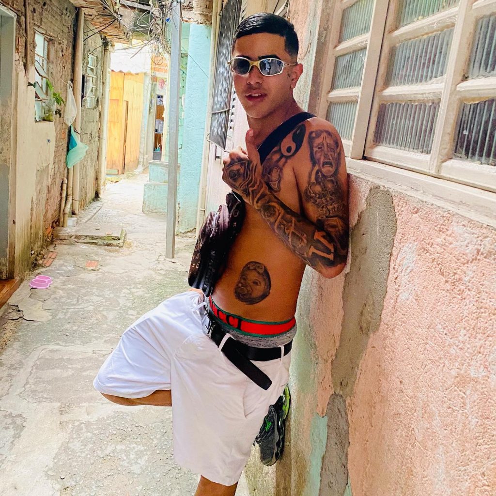 Favela funk rapper MC Vini VL was tragically shot dead outside a bar in Brazil after an argument sparked by jealousy over a kiss. The shooter is currently on the run.