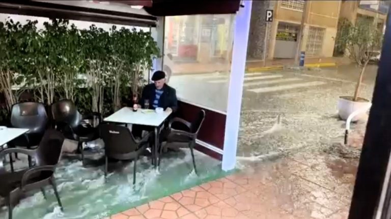 Chaos in Spain's Costa del Sol as torrential rains bring floods, evacuations, and quirky scenes—like a man kayaking with booze and another calmly sipping beer in the deluge!