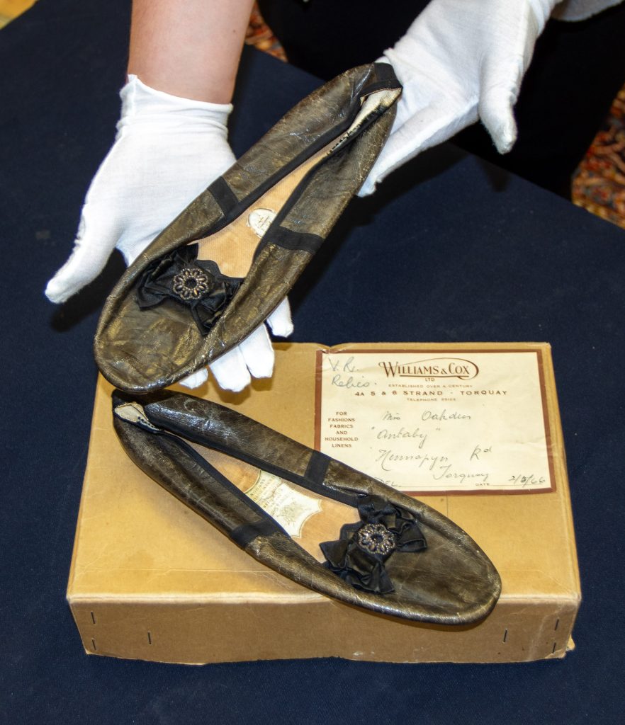 Queen Victoria’s vintage bloomers, chemise, and shoes, found in a Somerset wardrobe, head to auction with bids expected in the thousands. A rare royal memorabilia find!