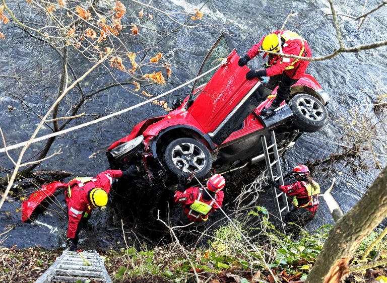 Heroic rescue as a passer-by saves a woman after her car plunges 14ft into a freezing Devon river. See how emergency crews braved challenges to bring her to safety!