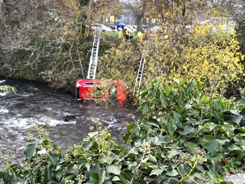 Heroic rescue as a passer-by saves a woman after her car plunges 14ft into a freezing Devon river. See how emergency crews braved challenges to bring her to safety!