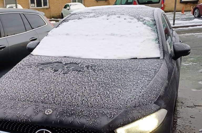 "Driver mimics Ace Ventura with head out window, navigating snow-covered roads in Liverpool. Police slam the reckless stunt, leaving locals baffled and the internet buzzing!"