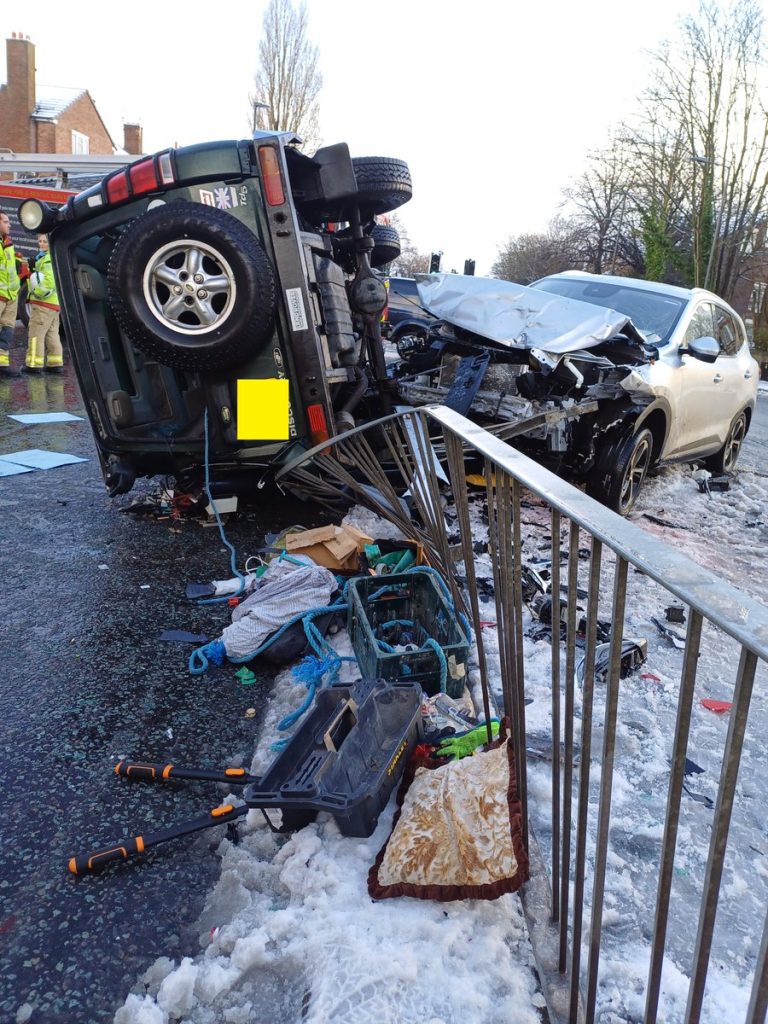 "Driver mimics Ace Ventura with head out window, navigating snow-covered roads in Liverpool. Police slam the reckless stunt, leaving locals baffled and the internet buzzing!"