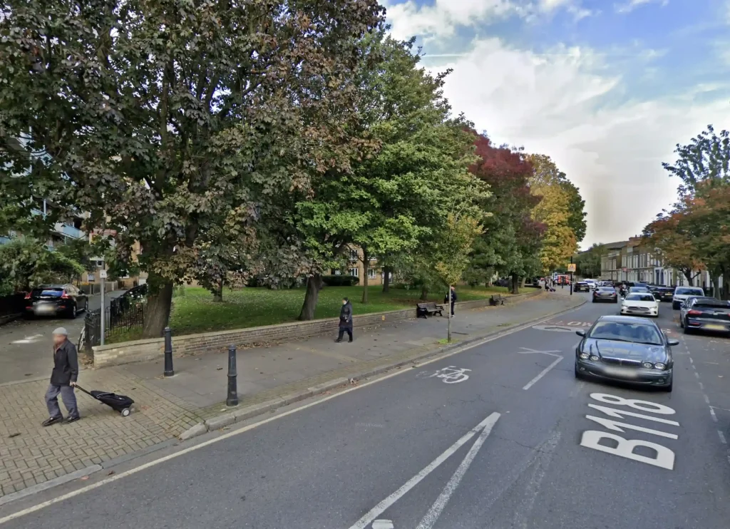 Two men brawl in a dramatic road rage clash on a busy London street, complete with a martial arts move, a downed moped, and chaos likened to a real-life *EastEnders* scene.