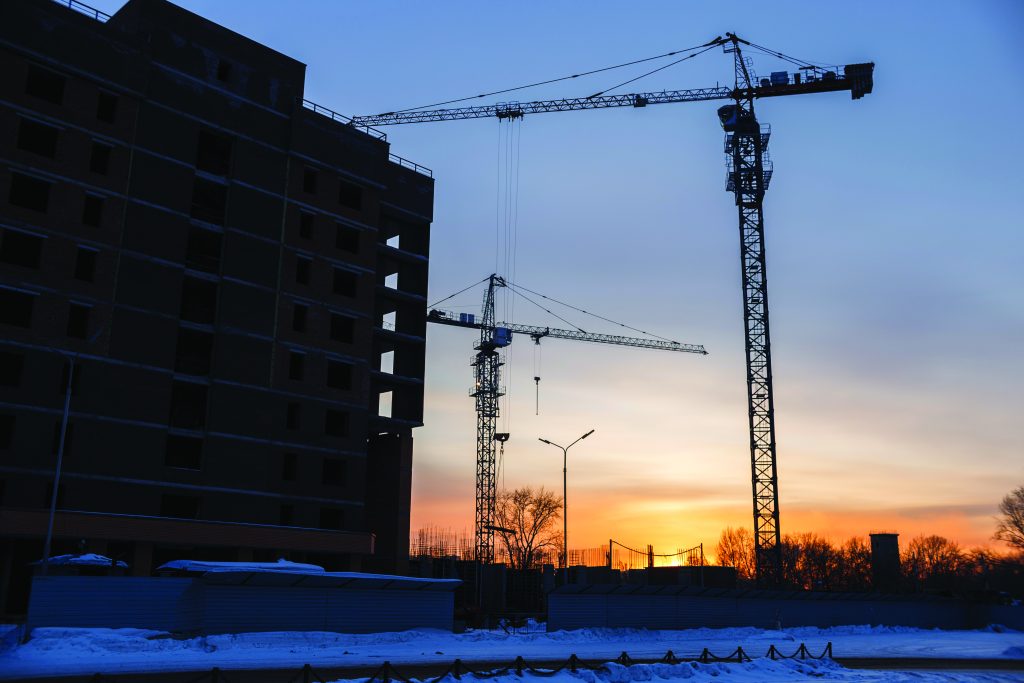 Cranes and building site twilight shutterstock 1054985435 Yevtin