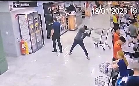 A furious husband attacked his wife's boss with a shovel in a shocking supermarket assault caught on CCTV. The manager's phone may have saved his life!