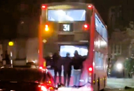 Four reckless youths were caught bus surfing in London, clinging to a speeding double-decker in a *GTA*-style stunt—risking serious injury and sparking outrage.