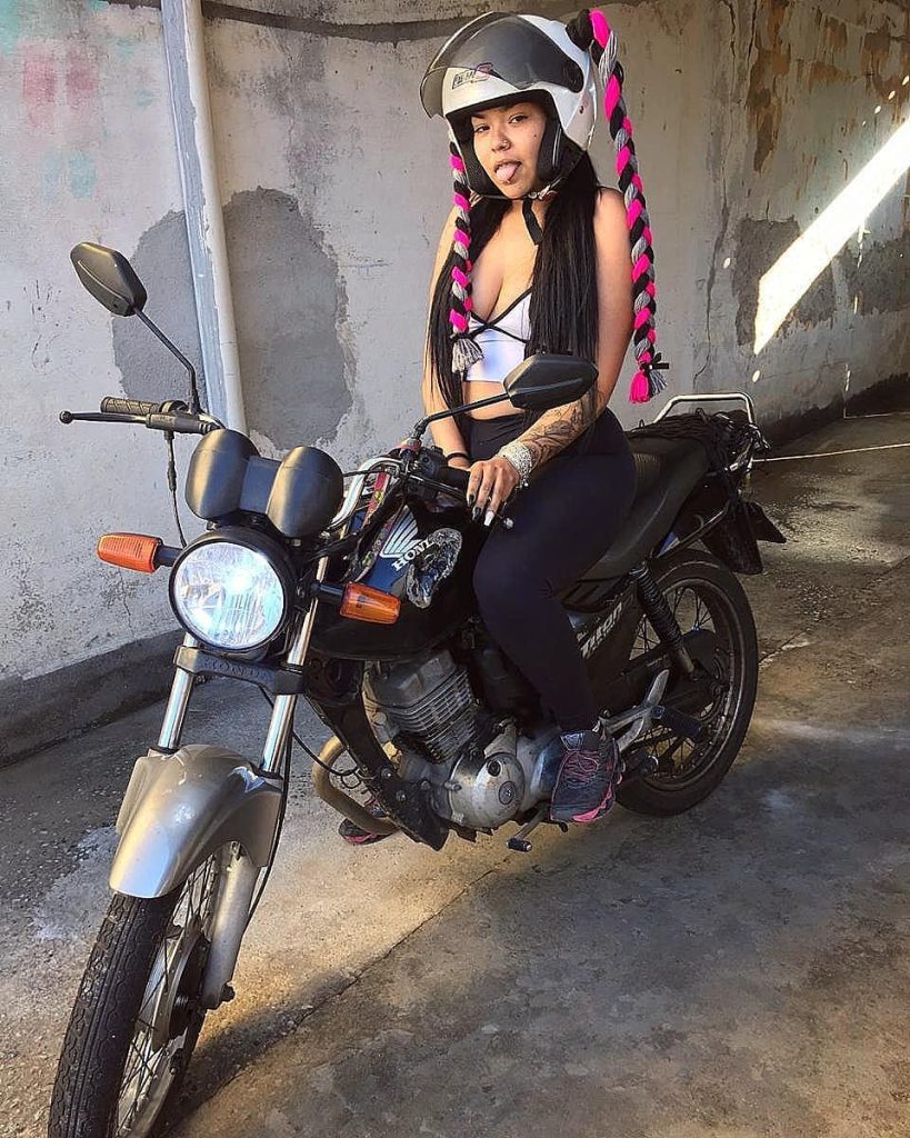 Brazilian motorbike influencer Keety Caroline crashes after colliding with a car, which speeds off without stopping. The viral video sparks heated debate online.