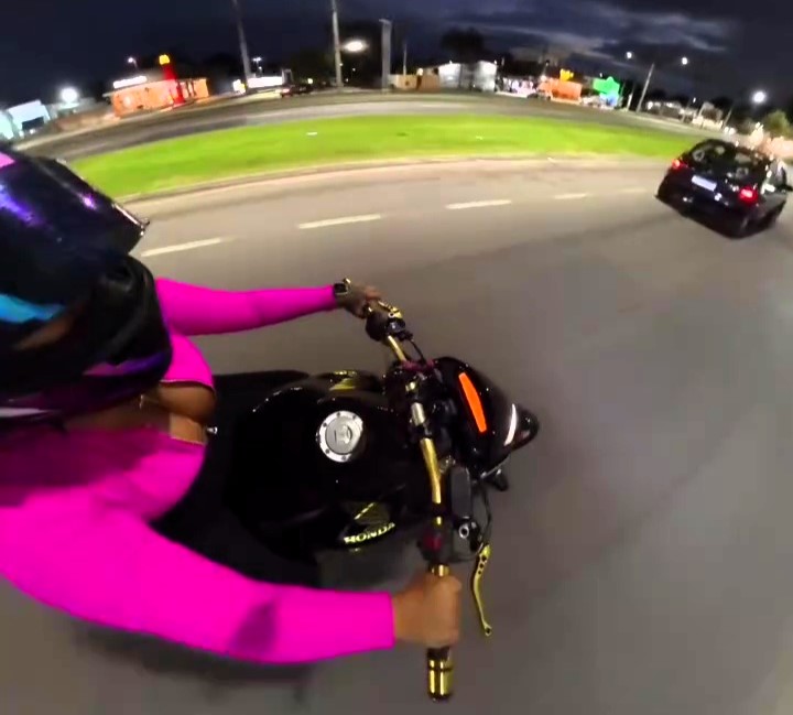 Brazilian motorbike influencer Keety Caroline crashes after colliding with a car, which speeds off without stopping. The viral video sparks heated debate online.