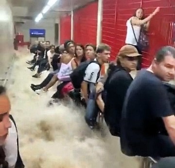 Commuters clung to handrails as floodwaters surged through a São Paulo metro station after record rainfall. See how the city battled chaos and restored operations.