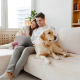 happy couple dog sofa mobile phone laptop