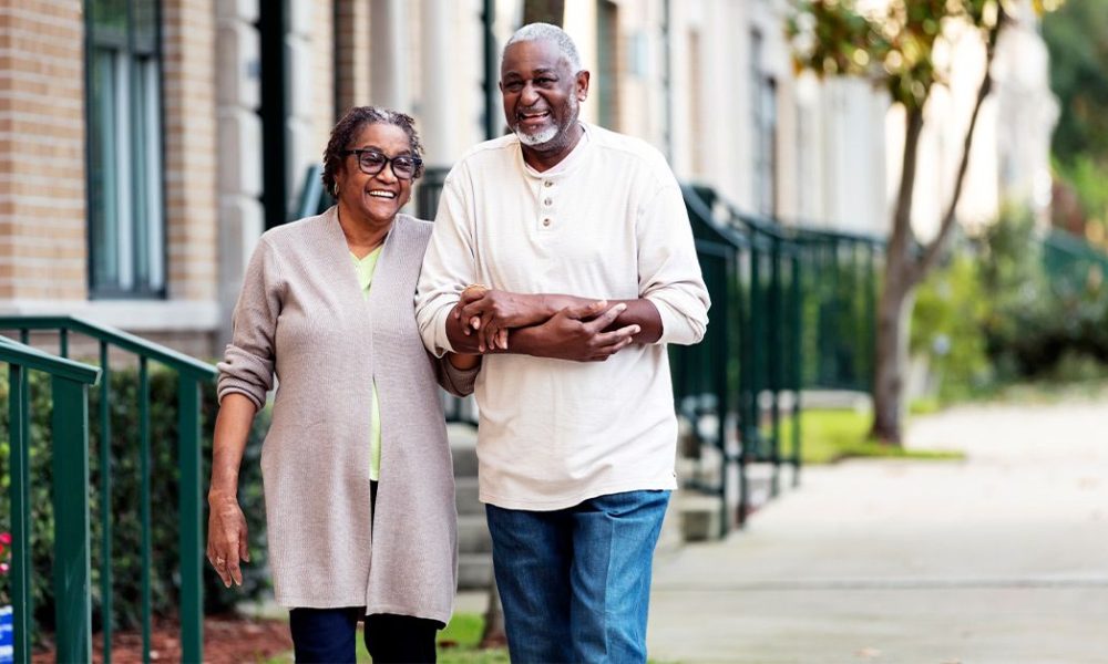 older couple wakling sidewalk 1200x628 facebook