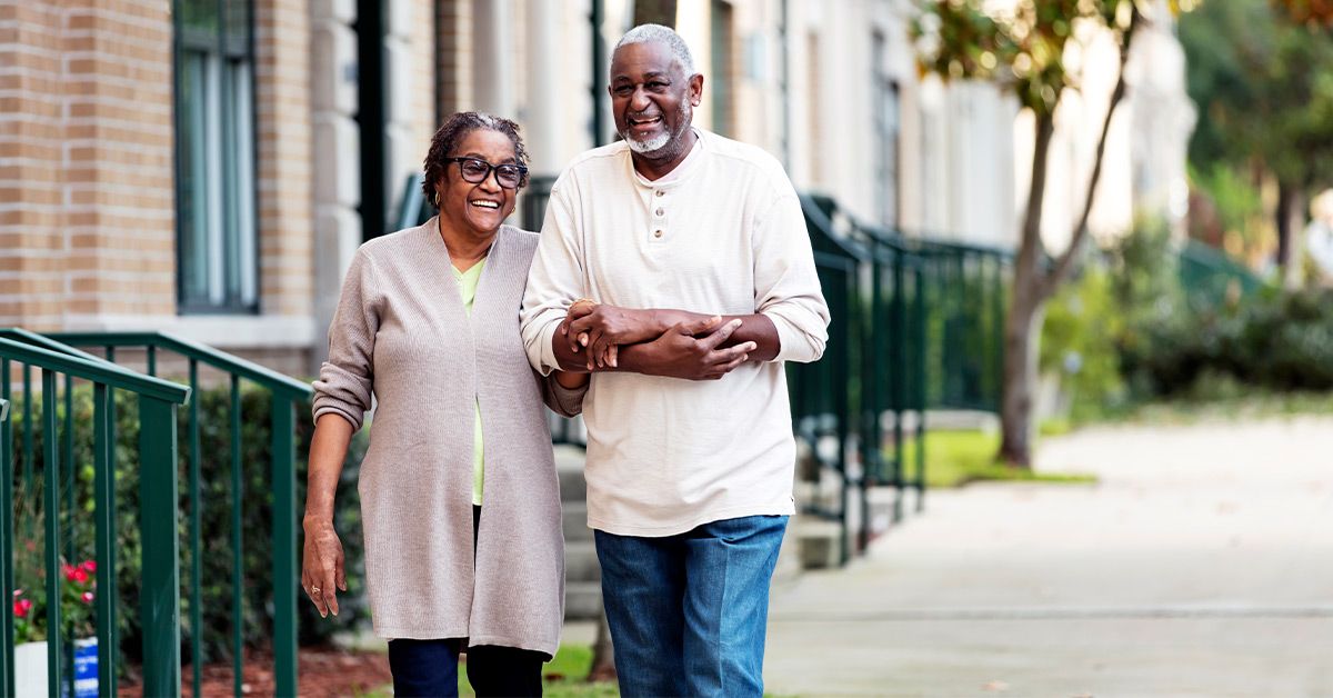 older couple wakling sidewalk 1200x628 facebook