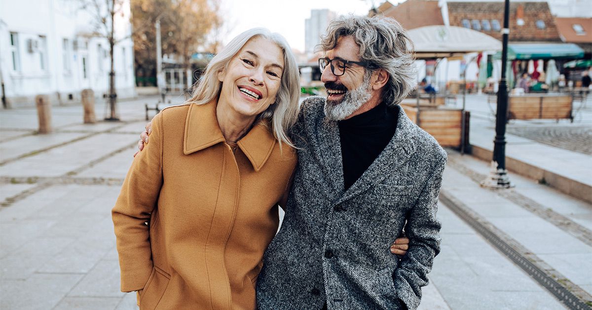 older couple walking outside smiles 1200x628 facebook