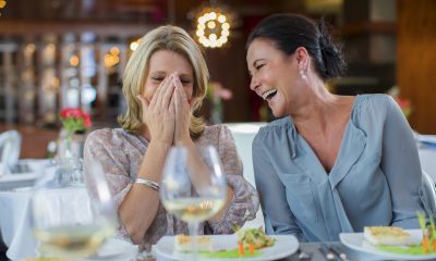 two women laugh restaurant