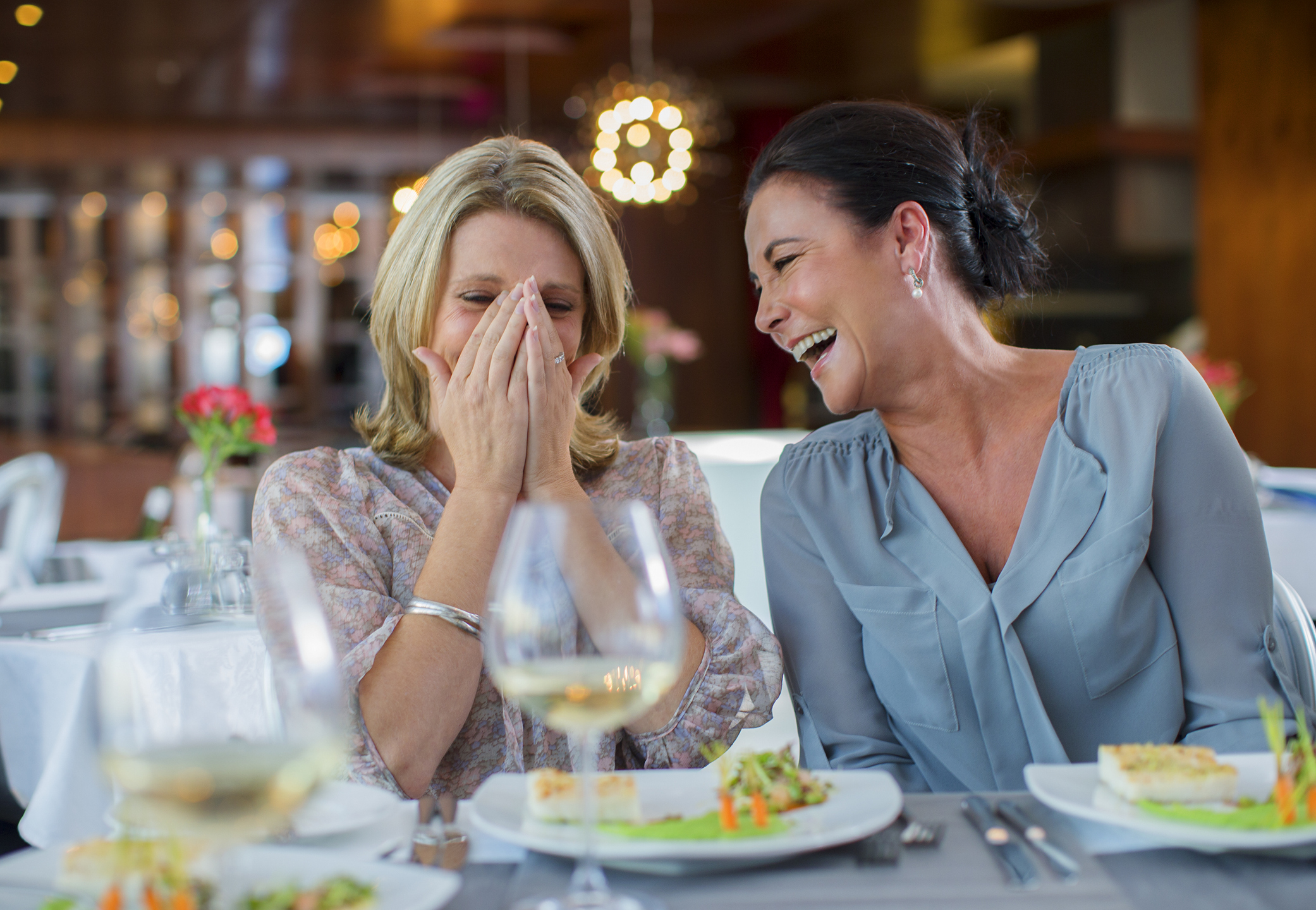 two women laugh restaurant