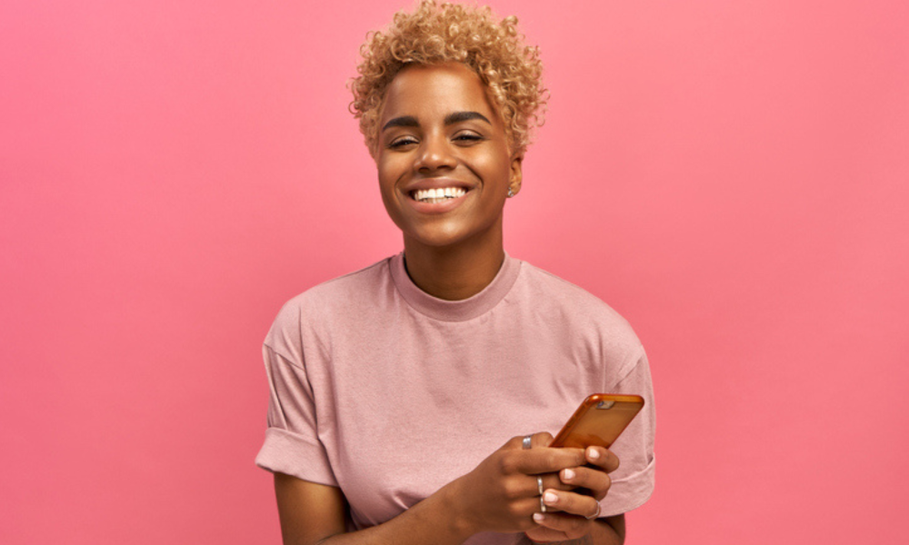 woman pink shirt pink background mobile phone