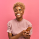 woman pink shirt pink background mobile phone