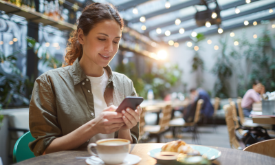 woman smartphone coffee croissant terrace coffee shop