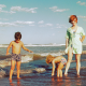 family enjoying beach trip out