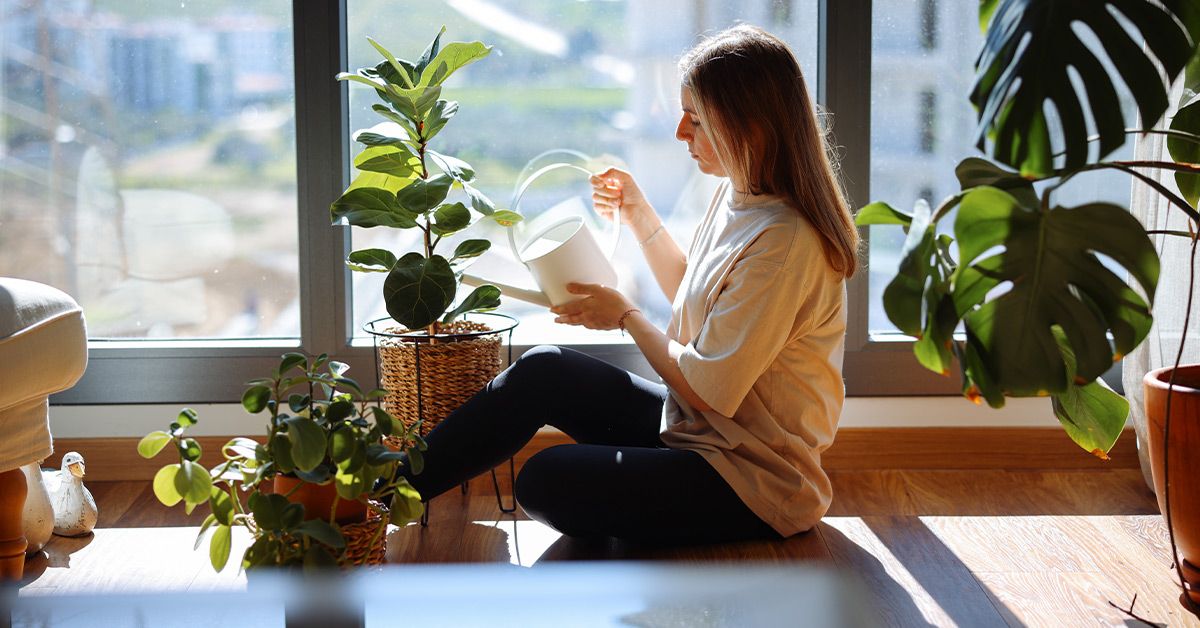 female watering plants 1200x628 facebook