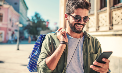 man wearing sunglasses shopping outside mobile phone