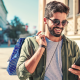 man wearing sunglasses shopping outside mobile phone