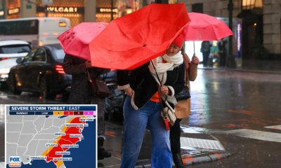 new yorkers walk heavy rain 100516599