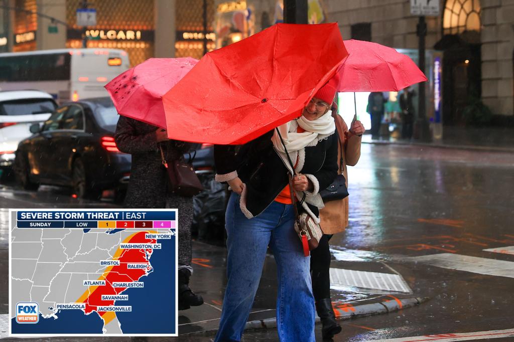 new yorkers walk heavy rain 100516599