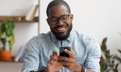 stylish businessman glasses uses mobile phone office