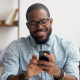 stylish businessman glasses uses mobile phone office