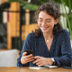 woman glasses sits desk mobile phone office