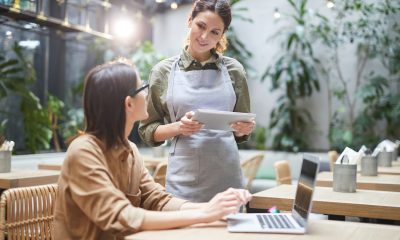 woman laptop speaking waitress