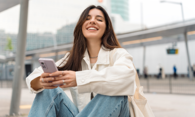 woman oversized white shirt blue jeans smiles