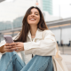 woman oversized white shirt blue jeans smiles