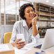 woman store owner working warehouse laptop phone